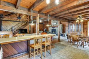 a kitchen and dining room of a log cabin at Lock Haven Cabin with Wood Stove and Mountain View! in Lock Haven