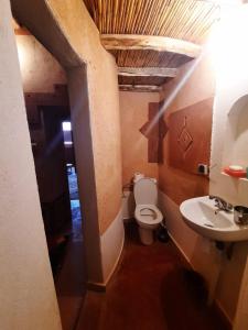 a small bathroom with a toilet and a sink at Gorges View Dades in Tamellalt