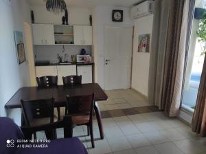 a kitchen and dining room with a table and chairs at Eilat in Eilat