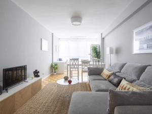 a living room with a gray couch and a fireplace at Apartamento Vigo, 3 dormitorios, 7 personas - ES-210-3 in Vigo