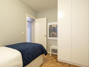 a white bedroom with a bed and a closet at Apartamento Vigo, 3 dormitorios, 7 personas - ES-210-3 in Vigo