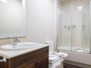 a white bathroom with a sink and a shower at Apartamento Vigo, 3 dormitorios, 7 personas - ES-210-3 in Vigo