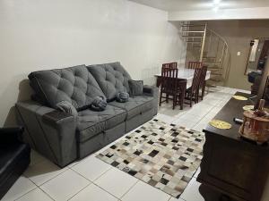 a living room with a couch and a table at Pousada Fabia e Fabio in São Gabriel