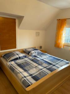 a bedroom with a bed with two pillows on it at Ferienhaus Pacco in Wermelskirchen