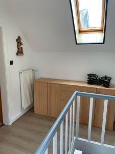 a room with a staircase and a window and a cabinet at Ferienhaus Pacco in Wermelskirchen