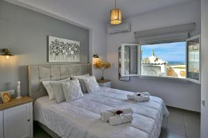 a bedroom with a large bed with towels on it at Villa Thalassa in Milatos