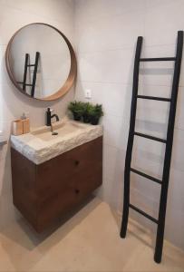 a bathroom with a sink and a mirror at Quinta das Pedras - Tavira in Tavira
