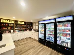 a large kitchen with a large refrigerator in a store at Cape Cod Family Resort and Parks in West Yarmouth
