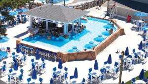 an overhead view of a pool with chairs and umbrellas at Cape Cod Family Resort and Parks in West Yarmouth