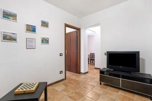 a living room with a flat screen tv on a wall at Casa Vacanze Il Torchio in Calice al Cornoviglio