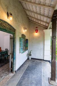 a porch of a house with a potted plant at Villa 1925 in Habaraduwa