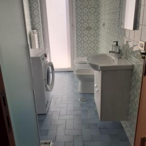 a bathroom with a sink and a toilet at Casa Nina in Putignano +18 photos