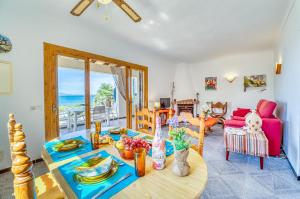 a living room with a table with food on it at Ideal Property Mallorca - Casa Sa Nau in Artá