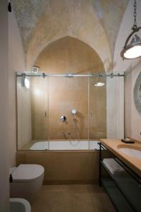 a bathroom with a shower and a toilet and a sink at Casa Galateo 20 in Gallipoli