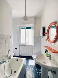 a bathroom with a tub and a sink and a mirror at ‘La Casa di Rosa’ in Levanto