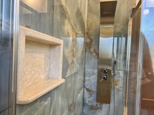 a shower with a glass door in a bathroom at Villa Grecale in Cala Liberotto +47 photos