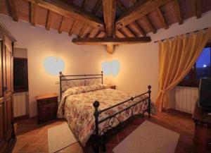 a bedroom with a bed and a television in it at LA CASA DEL CALZOLAIO in Radicofani