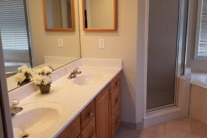 a bathroom with two sinks and a shower at Black Diamond Beauty with Concierge Service in Lecanto