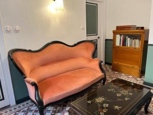 a couch in a living room with a table at Les Dames de Saint Florent in Saint-Florent-sur-Auzonnet