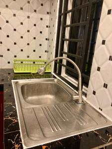 a sink in a kitchen with a faucet at Lotus Haven Villa in Siem Reap