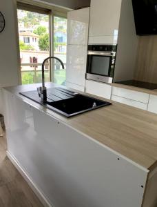 a kitchen with a counter with a laptop on it at Cosy Flat Cannes in Le Cannet