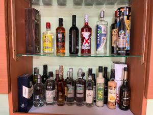 a cabinet filled with lots of bottles of alcohol at Vatican city gardens hideout kaleo in Wa