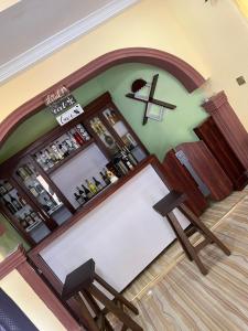an overhead view of a bar with a cross on the wall at Vatican city gardens hideout kaleo in Wa