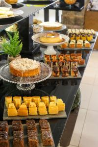 a display case with many different types of desserts at Flat Pietra in Florianópolis