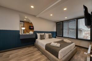 a bedroom with a large bed with a blue wall at Swans Hotel Old City Grand Bazaar in Istanbul