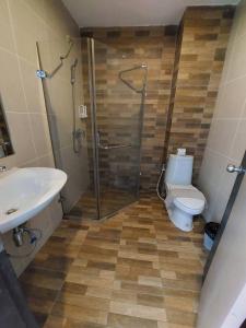 a bathroom with a shower and a toilet and a sink at GO INN Aonang Beach โกอินน์ หาดอ่าวนาง in Ban Khlong Haeng +10 photos