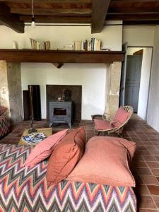 a living room with a bed and a fireplace at Maison proche Marciac, 3 chambres in Armous-et-Cau