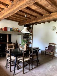 a dining room with a black table and chairs at Maison proche Marciac, 3 chambres in Armous-et-Cau