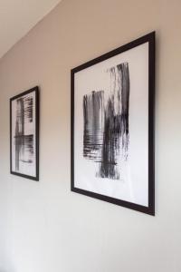 two framed pictures hanging on a wall at Linwood House in Paisley