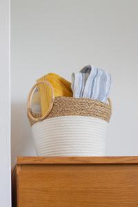 a basket of towels sitting on top of a drawer at Spacious & bright 4-bedroom town-house with garden in Sydenham