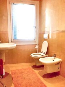 baño con aseo y lavabo y ventana en One bedroom apartement with city view and wifi at Venezia, en Venecia