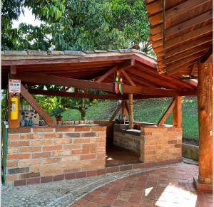 - un pavillon en bois avec un mur en briques dans l'établissement Finca rincón del paraíso, à Los Andes