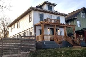 a house with a large deck on the front of it at Spacious 5BR/5.5BA Near Plaza & Museum in Kansas City