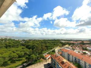 a view of the city and the ocean from a building at Almada apartamento T1 - 1 Renovado, Laranjeiro in Almada