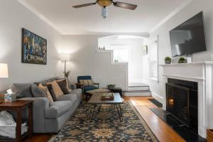 a living room with a couch and a fireplace at Cincy East Side Cottage the best of Hyde Park in Cincinnati