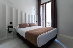 Postel nebo postele na pokoji v ubytování Hostal Gran Via 44