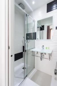 a bathroom with a glass shower and a sink at Hostal Gran Via 44 in Madrid