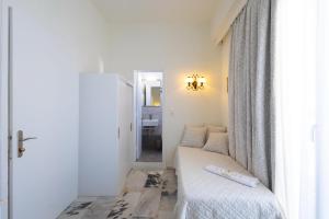 Postel nebo postele na pokoji v ubytování Kymata Hotel