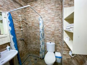a bathroom with a shower and a toilet and a sink at Dar Statia 4 vue mer cité portugaise in El Jadida