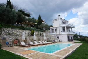 a villa with a swimming pool and a house at Villa Artemis Nafplion in Tolo