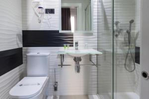 uma casa de banho com um WC, um lavatório e um chuveiro em Hostal Gran Via 44 em Madri