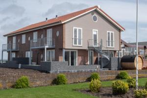 a house with a staircase in front of it at Residentie Oosterschelde in Sint Philipsland