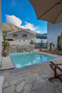 a swimming pool in front of a house at Anassa Mountain House in Émbonas