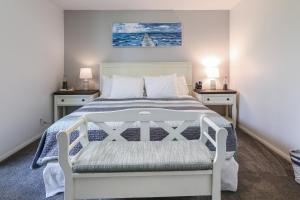 a bedroom with a white bed with two night stands at D4 - Lighthouse on the Shore in Oceanside +51 photos