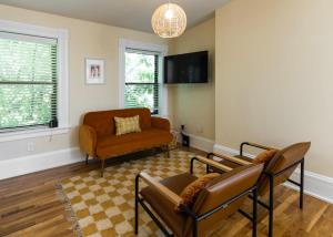 a living room with a couch and a chair at The Heart of OTR - Central studio apartment in Cincinnati