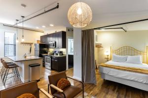 a hotel room with a bed and a kitchen at The Heart of OTR - Central studio apartment in Cincinnati